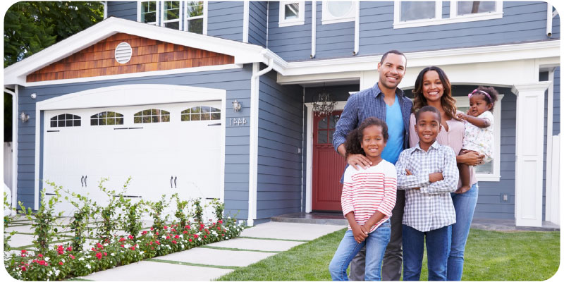 family standing in front of home